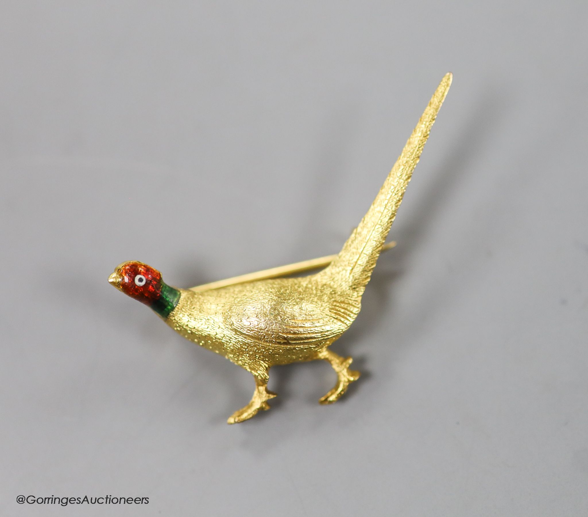 An early 20th century 9ct and polychrome enamel pheasant brooch, 42mm, gross weight 6.4 grams.